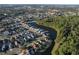 Aerial view showing home's location in a quiet residential neighborhood near a lake at 2981 Viscount Cir, Kissimmee, FL 34747