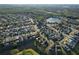 Aerial view showing home's location in a quiet residential neighborhood near a lake at 2981 Viscount Cir, Kissimmee, FL 34747