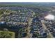 Aerial view showing home's location in a quiet residential neighborhood near a lake at 2981 Viscount Cir, Kissimmee, FL 34747