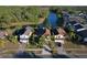 Aerial view of homes near a lake, each with well-maintained lawns and some with screened pools at 2981 Viscount Cir, Kissimmee, FL 34747