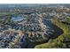 Aerial view showing home's location in a quiet residential neighborhood near a lake at 2981 Viscount Cir, Kissimmee, FL 34747