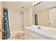 Well-lit bathroom features a tub with shower and a large mirror above the sink at 2981 Viscount Cir, Kissimmee, FL 34747