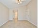 Spacious bedroom features neutral walls, tiled floor, ceiling fan and hallway leading to other rooms at 2981 Viscount Cir, Kissimmee, FL 34747