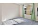 Bedroom with grey carpet and a window with light green curtains at 2981 Viscount Cir, Kissimmee, FL 34747
