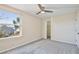 Bedroom with ceiling fan, large window, and walk-in closet at 2981 Viscount Cir, Kissimmee, FL 34747