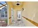 Inviting entrance with stone floor, fan, and decorative sconce light at 2981 Viscount Cir, Kissimmee, FL 34747