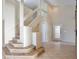 Bright foyer features wood stairs, glass railing, and tile flooring at 2981 Viscount Cir, Kissimmee, FL 34747