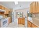 Bright kitchen with stainless steel appliances and center island overlooking pool at 2981 Viscount Cir, Kissimmee, FL 34747