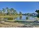 Stunning lake view from backyard with lush green landscape at 2981 Viscount Cir, Kissimmee, FL 34747