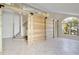 Living room features a decorative sliding wood door and stairway at 2981 Viscount Cir, Kissimmee, FL 34747