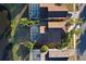 Backyard aerial view of houses with screened-in pools, and mature landscaping near the water at 2981 Viscount Cir, Kissimmee, FL 34747