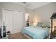 Bright bedroom with light blue bedding and plenty of closet space at 31921 Redtail Reserve Blvd, Sorrento, FL 32776