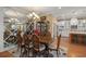 Elegant dining room with hardwood floors, large table and mirrored wall at 31921 Redtail Reserve Blvd, Sorrento, FL 32776