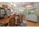 Open dining room with hardwood floors, large table, and access to kitchen at 31921 Redtail Reserve Blvd, Sorrento, FL 32776