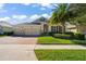 Beautiful house exterior with lush landscaping and a three car garage at 31921 Redtail Reserve Blvd, Sorrento, FL 32776