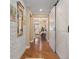 Bright entryway with hardwood floors, white brick wall, and barn door at 31921 Redtail Reserve Blvd, Sorrento, FL 32776
