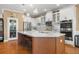 Modern kitchen boasts white cabinets, large island, and stainless steel appliances at 31921 Redtail Reserve Blvd, Sorrento, FL 32776