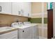 Laundry room with washer, dryer and cabinets at 31921 Redtail Reserve Blvd, Sorrento, FL 32776