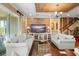 Spacious living room features wood accent wall, comfy sofas, and large TV at 31921 Redtail Reserve Blvd, Sorrento, FL 32776
