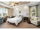 Relaxing main bedroom with white brick accent wall and comfortable seating area at 31921 Redtail Reserve Blvd, Sorrento, FL 32776