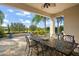 Covered patio with table and chairs, overlooking garden at 31921 Redtail Reserve Blvd, Sorrento, FL 32776