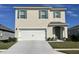 Two-story house with a white garage door and green shutters at 3428 Costello Cir, Winter Haven, FL 33884