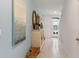 Light and airy hallway with tile floors and coastal decor at 3428 Costello Cir, Winter Haven, FL 33884