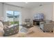 Bright living room featuring comfortable seating, large TV, and sliding glass doors leading to backyard at 3428 Costello Cir, Winter Haven, FL 33884