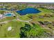 Aerial view of a golf course community with a lake at 3900 Southpointe Dr # 127, Orlando, FL 32822