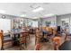Community room with tables, chairs, and bookshelves at 3900 Southpointe Dr # 127, Orlando, FL 32822