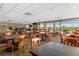 Community room with tables and chairs, overlooking a golf course at 3900 Southpointe Dr # 127, Orlando, FL 32822