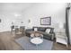 Comfortable living room featuring a gray sectional sofa and hardwood floors at 3900 Southpointe Dr # 127, Orlando, FL 32822