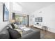 Bright living room with gray sectional sofa and access to balcony at 3900 Southpointe Dr # 127, Orlando, FL 32822