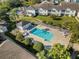 Community pool with surrounding patio furniture and landscaping at 3900 Southpointe Dr # 127, Orlando, FL 32822