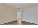 Comfortable bedroom with wood floors, a closet with louvered doors, and access to the ensuite bathroom at 412 Summit Ridge Pl # 210, Longwood, FL 32779