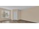 This bedroom features wood floors, a large window, and a closet with a louvered door at 412 Summit Ridge Pl # 210, Longwood, FL 32779