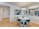 White round dining table with four light teal chairs in a well-lit space at 4153 S Atlantic Ave # 3070, New Smyrna Beach, FL 32169