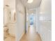 Clean hallway with light flooring and access to bathroom at 4153 S Atlantic Ave # 3070, New Smyrna Beach, FL 32169