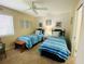 Bedroom with twin beds, nightstands and ceiling fan at 4285 Sea Mist Dr, New Smyrna Beach, FL 32169