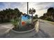 Sea Woods community entrance sign with palm trees and paved driveway at 4285 Sea Mist Dr, New Smyrna Beach, FL 32169