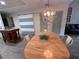 Dining area features a light wood table, chairs, and barn door at 4285 Sea Mist Dr, New Smyrna Beach, FL 32169