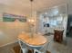 Dining area with light wood table and chairs, kitchen view at 4285 Sea Mist Dr, New Smyrna Beach, FL 32169