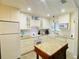 Galley style kitchen with granite countertops and island at 4285 Sea Mist Dr, New Smyrna Beach, FL 32169
