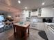 Bright kitchen with white cabinets, granite countertops, and island at 4285 Sea Mist Dr, New Smyrna Beach, FL 32169