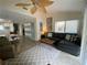 Living room with sectional sofa, access to patio, and large fan at 4285 Sea Mist Dr, New Smyrna Beach, FL 32169
