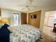Main bedroom with king bed, TV, and sliding door to patio at 4285 Sea Mist Dr, New Smyrna Beach, FL 32169