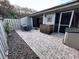 Brick paved patio with table and chairs, next to a fenced yard at 4285 Sea Mist Dr, New Smyrna Beach, FL 32169