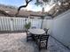 Outdoor patio with round table and chairs, surrounded by fence at 4285 Sea Mist Dr, New Smyrna Beach, FL 32169
