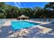 Community pool with lounge chairs and a shaded seating area at 4285 Sea Mist Dr, New Smyrna Beach, FL 32169