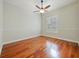 Bedroom featuring hardwood floors, ceiling fan, and a window with shutters at 4520 Old Carriage Trl, Oviedo, FL 32765